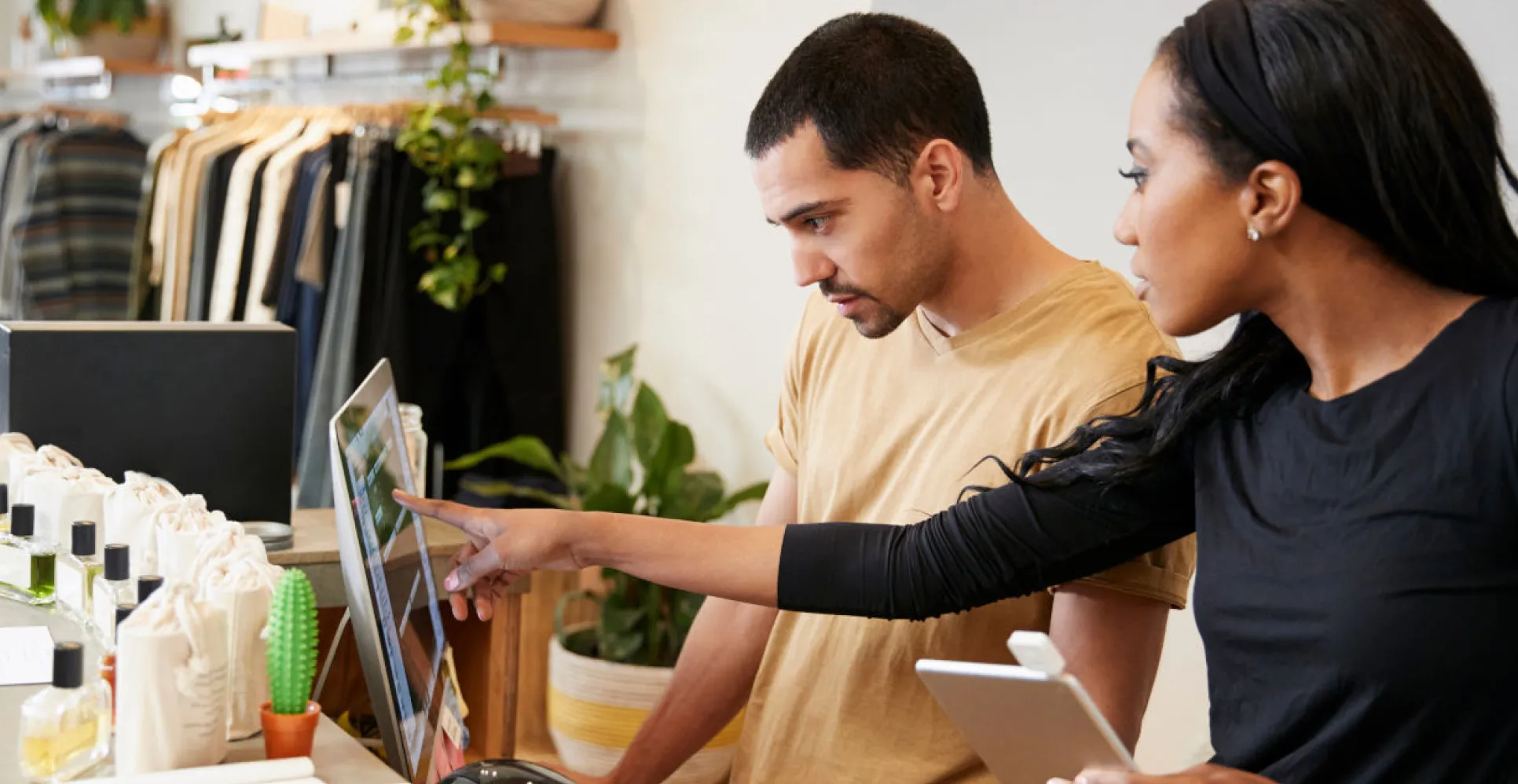 Two retail employees managing access on a Sempro tablet at the counter