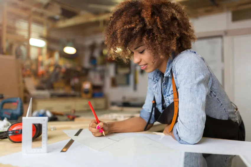 A Sempro technician sketching an installation plan at a workbench